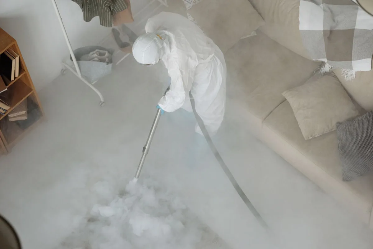 Biohazard cleanup technician in protective equipment, Schofield, WI
